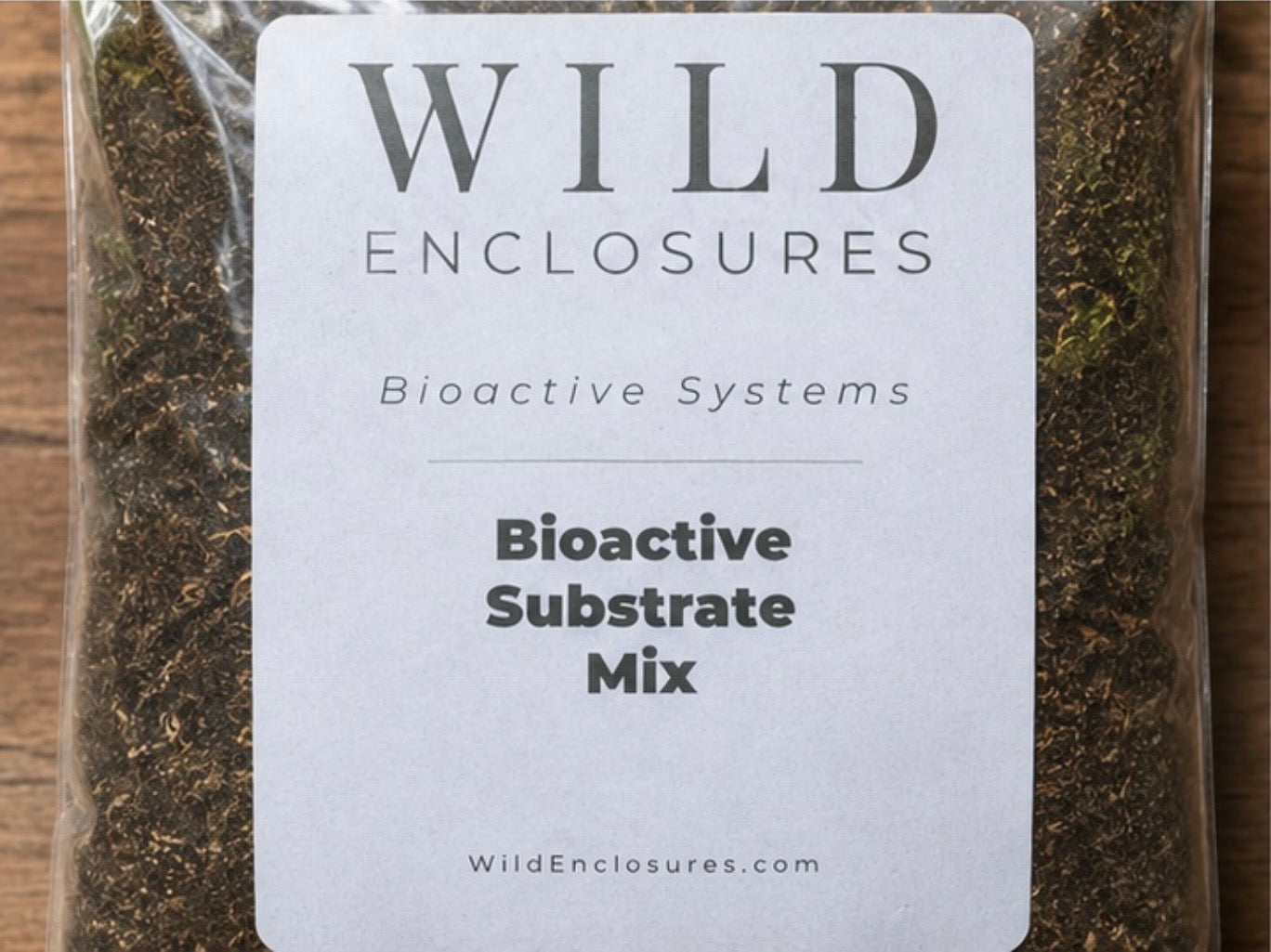 Close-up of Wild Enclosures Bioactive Substrate Mix packaging label on a bag of natural terrarium substrate. This ready-to-use bioactive soil blend supports isopods, springtails, beneficial microfauna, tropical plants, reptiles, amphibians, and healthy vivarium and terrarium ecosystems.