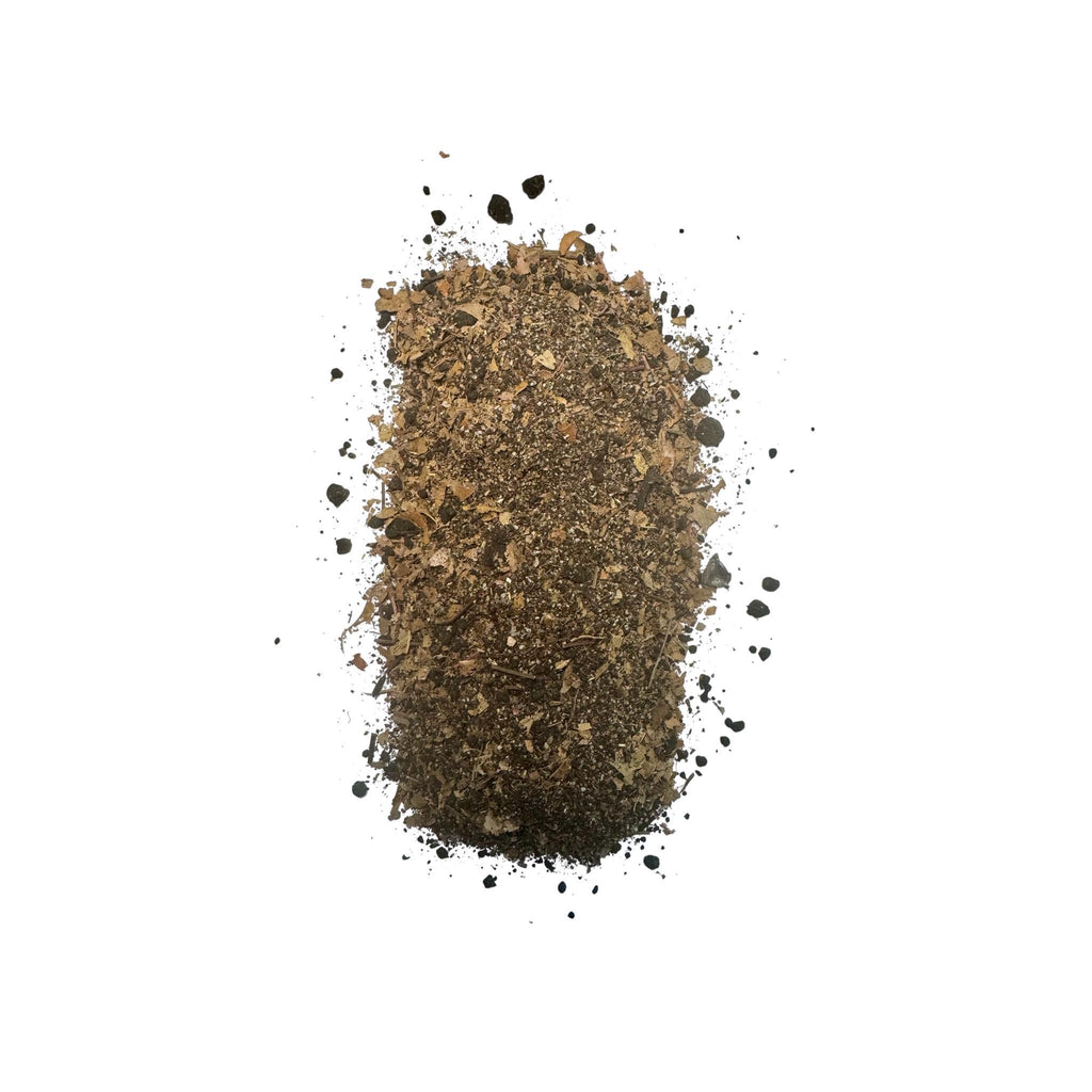 Close-up of SoilLife Booster bioactive soil amendment blend with leaf fragments and organic substrate mix on white background