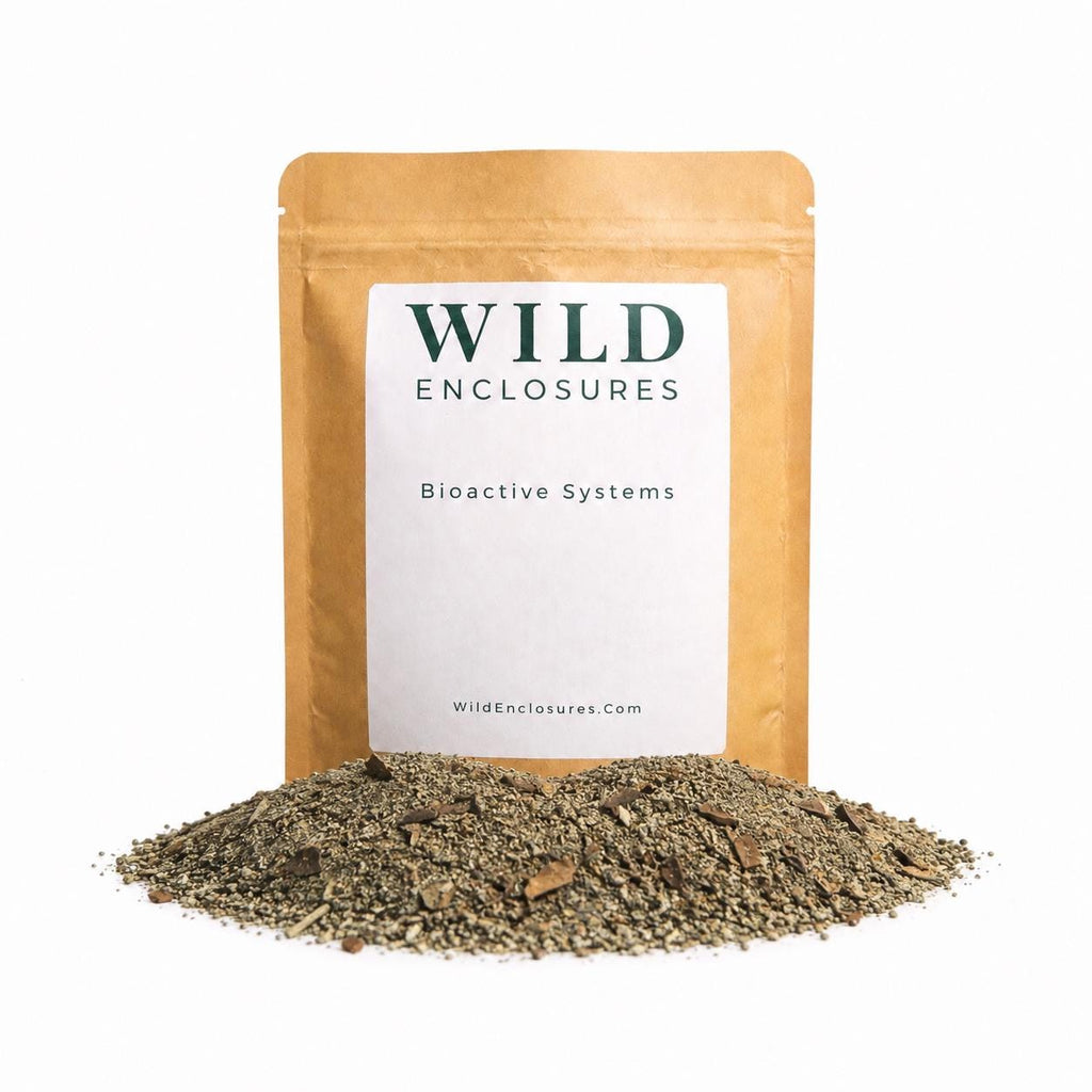 Wild Enclosures Isopod Food displayed in a kraft stand-up pouch with a white label on a clean white background. A pile of finely ground greenish-tan food granules is arranged in front of the package, showcasing a nutritious supplemental food blend designed for isopods and other bioactive cleanup crews.
